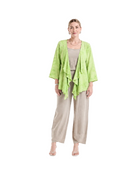 A woman modeling a light lime green open-front cardigan over a beige top and wide-leg beige pants, standing against a plain white studio background.
